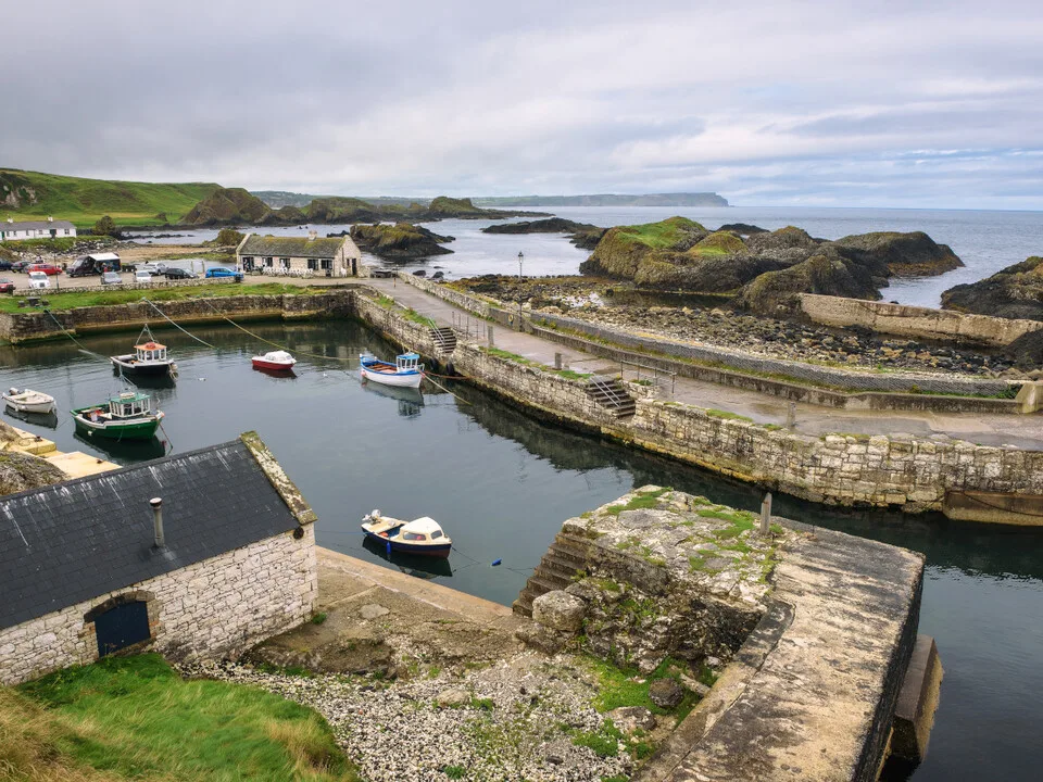 Small boats moored in the sheltered Ballintoy Harbour